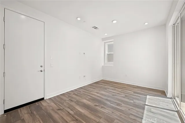 a view of room with wooden floor