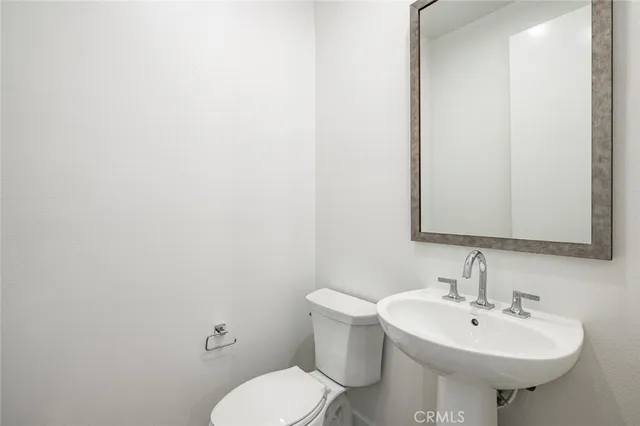 a bathroom with a sink a toilet and mirror