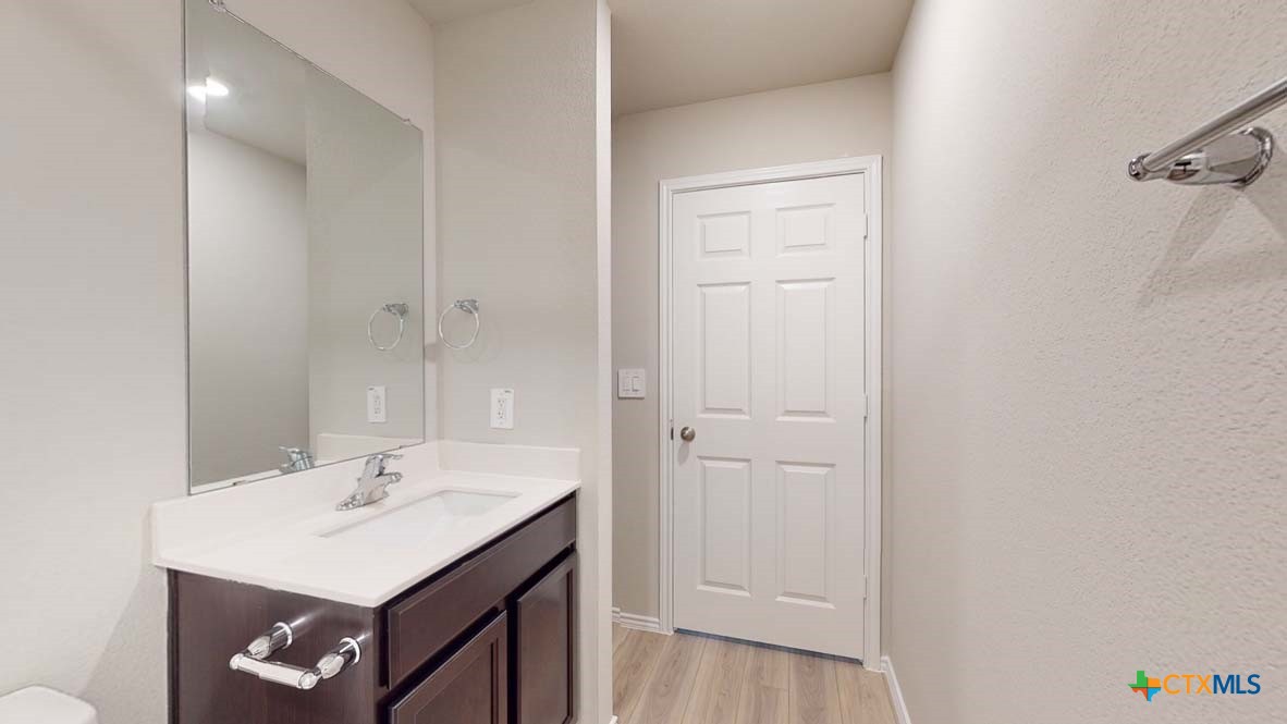 549 Hector Loop Georgetown, TX 78626 - Photo 22 of 22 a bathroom with a sink a vanity and a mirror