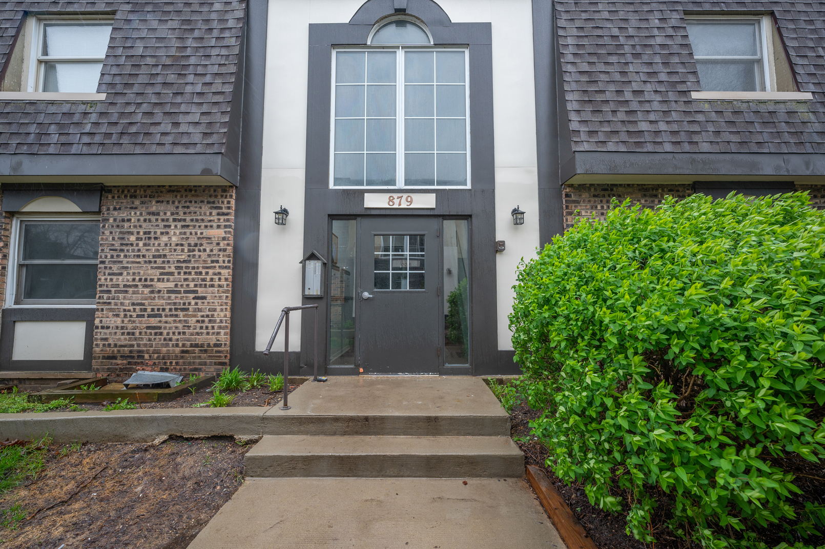 879 Trace Drive, Unit 202 Buffalo Grove, IL 60089 - Photo 1 of 15 a front view of a house with a yard