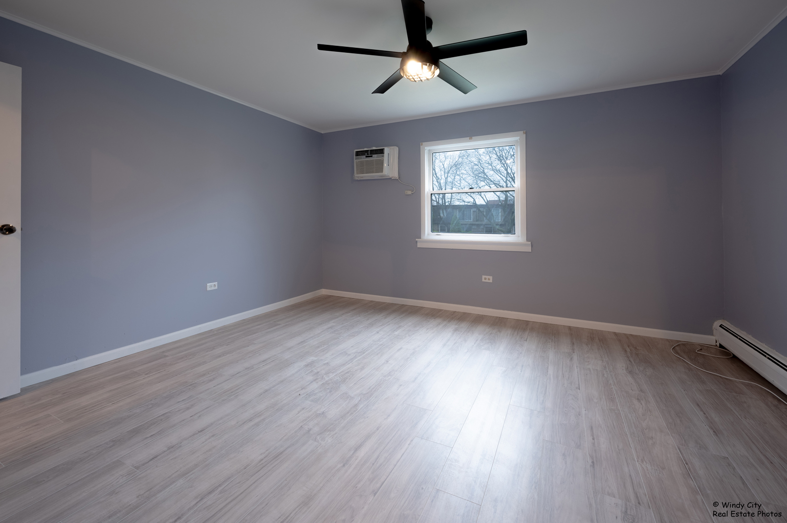 879 Trace Drive, Unit 202 Buffalo Grove, IL 60089 - Photo 12 of 15 wooden floor in an empty room with a window
