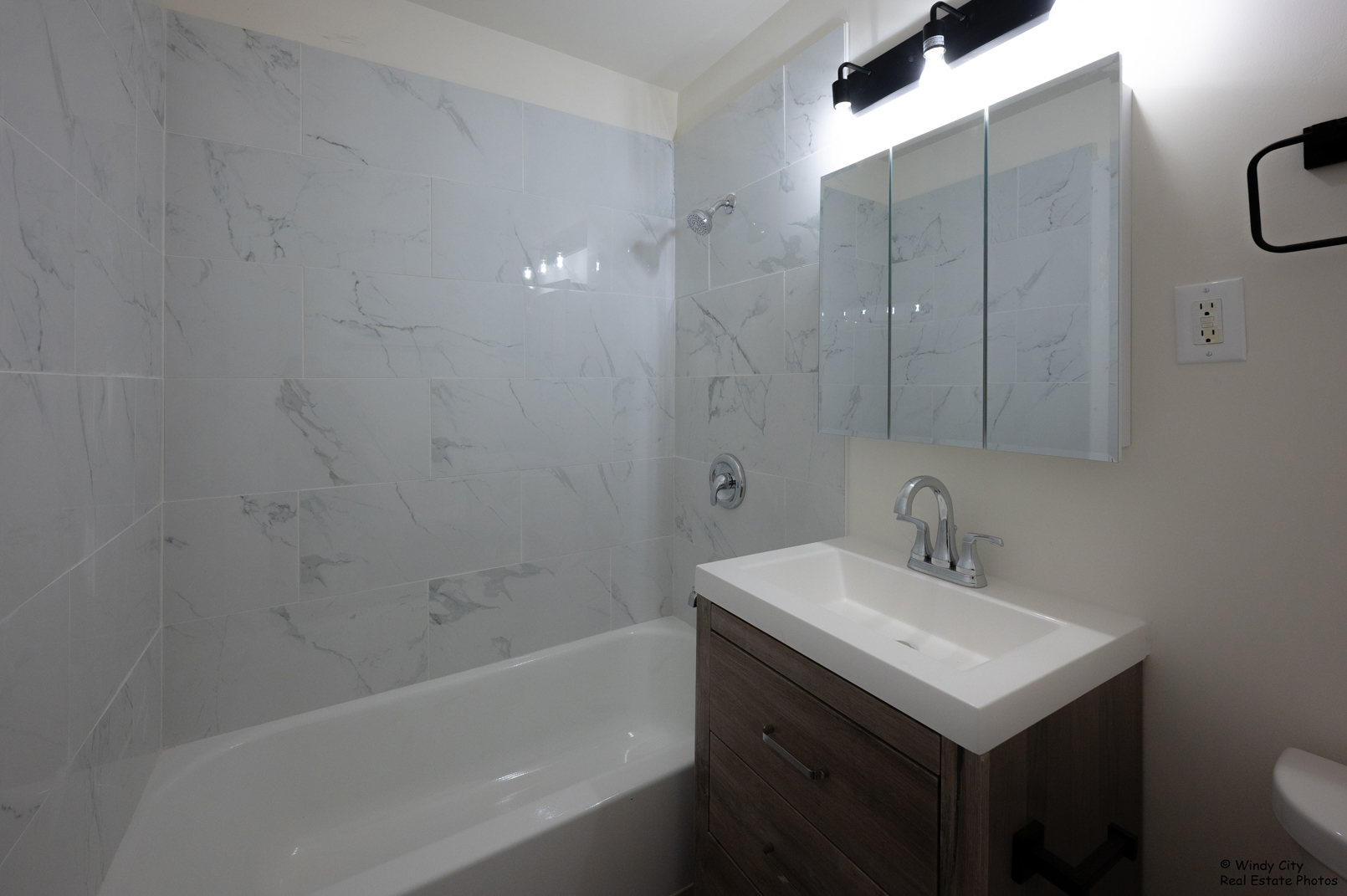 879 Trace Drive, Unit 202 Buffalo Grove, IL 60089 - Photo 13 of 15 a bathroom with a sink toilet and shower