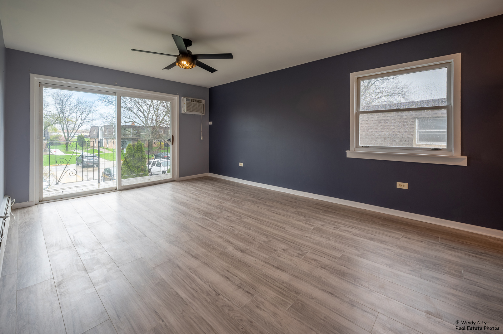 879 Trace Drive, Unit 202 Buffalo Grove, IL 60089 - Photo 5 of 15 an empty room with wooden floor and windows