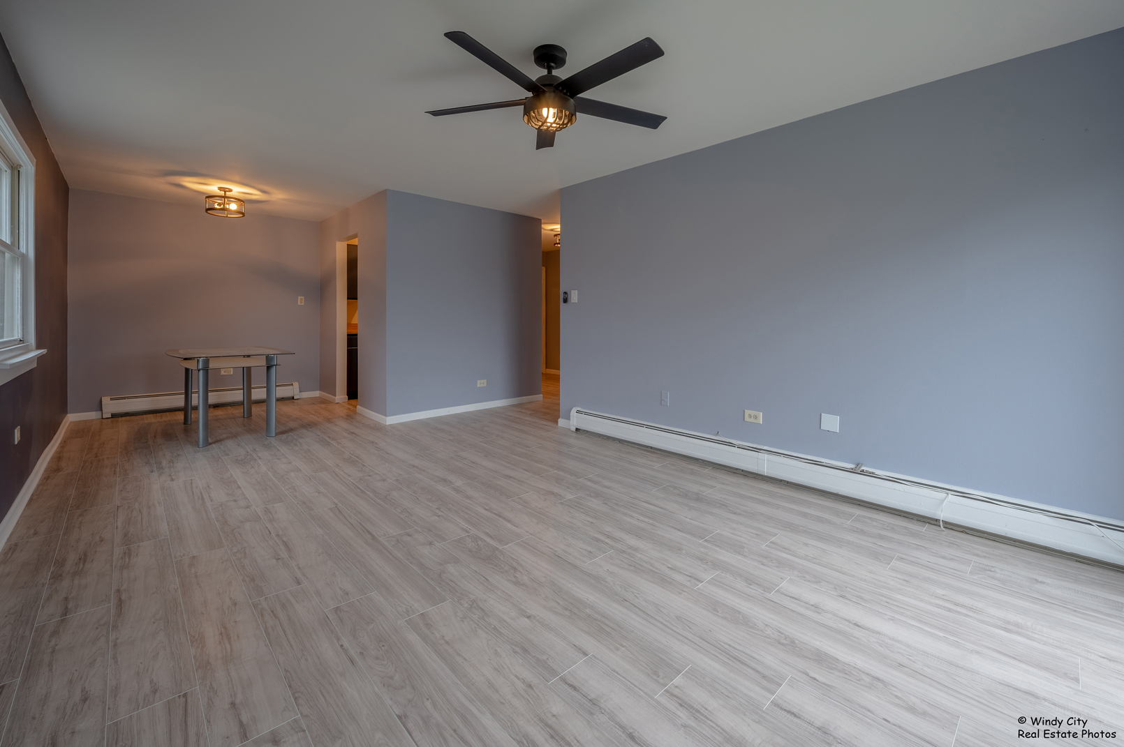 879 Trace Drive, Unit 202 Buffalo Grove, IL 60089 - Photo 7 of 15 a view of room with wooden floor and a ceiling fan