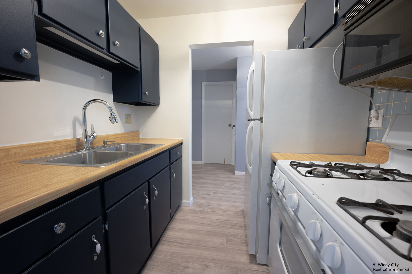 879 Trace Drive, Unit 202 Buffalo Grove, IL 60089 - Photo 8 of 15 a kitchen with stainless steel appliances granite countertop a sink stove and refrigerator