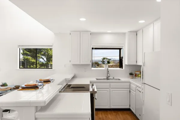 a kitchen with appliances a sink and cabinets