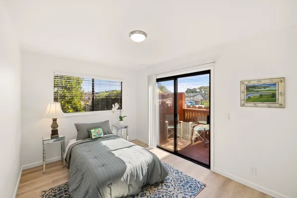 a bedroom with a bed and glass door