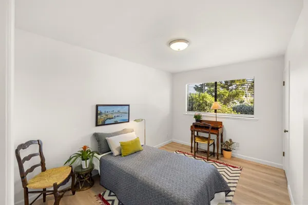 a bedroom with a bed and a chair