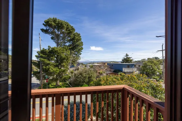 a view of a balcony with wooden fence and floor