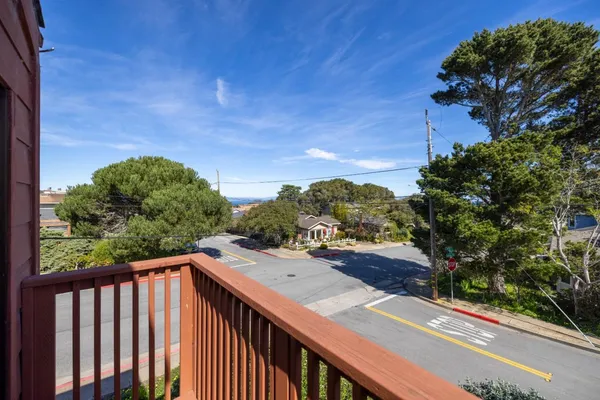 a view of a balcony with wooden fence