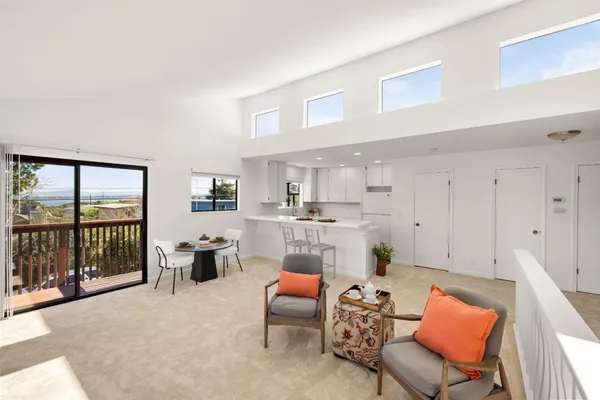 a living room with furniture a rug and a large window