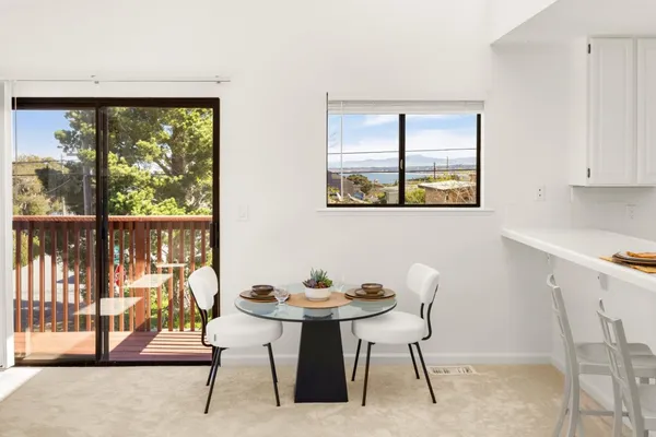 a view of a dining room with furniture window and outside view