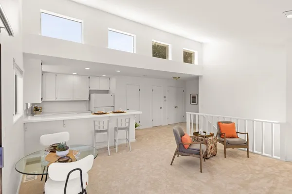 a living room with furniture a dining table and chairs
