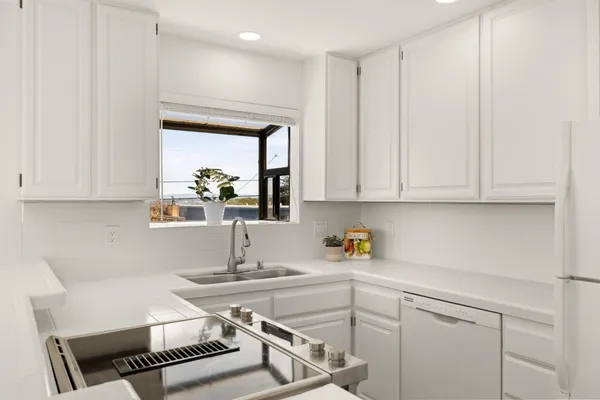 a kitchen with a sink cabinets and window