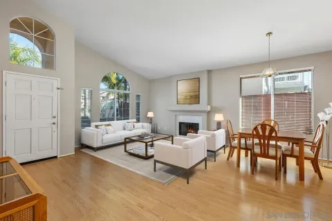 a living room with furniture fireplace and a large window