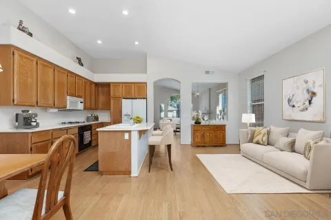 a living room with furniture and kitchen view