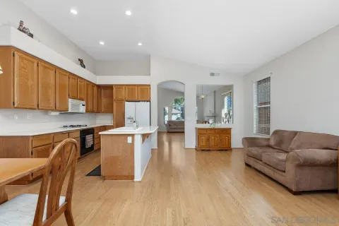 a kitchen with a sink dishwasher a stove and a refrigerator with wooden floor