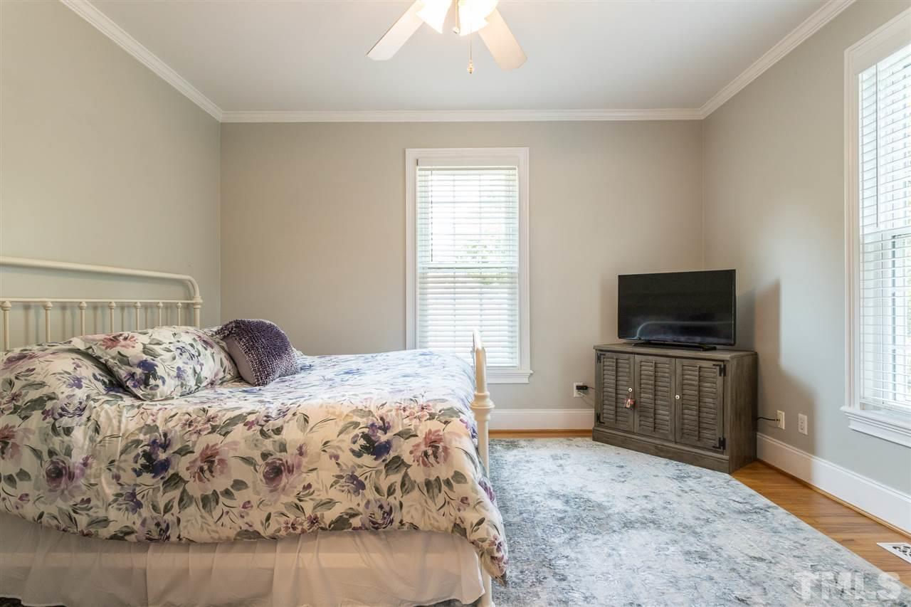 1208 Watauga Street Raleigh, NC 27604 - Photo 13 of 26 a bedroom with a bed and flat screen tv