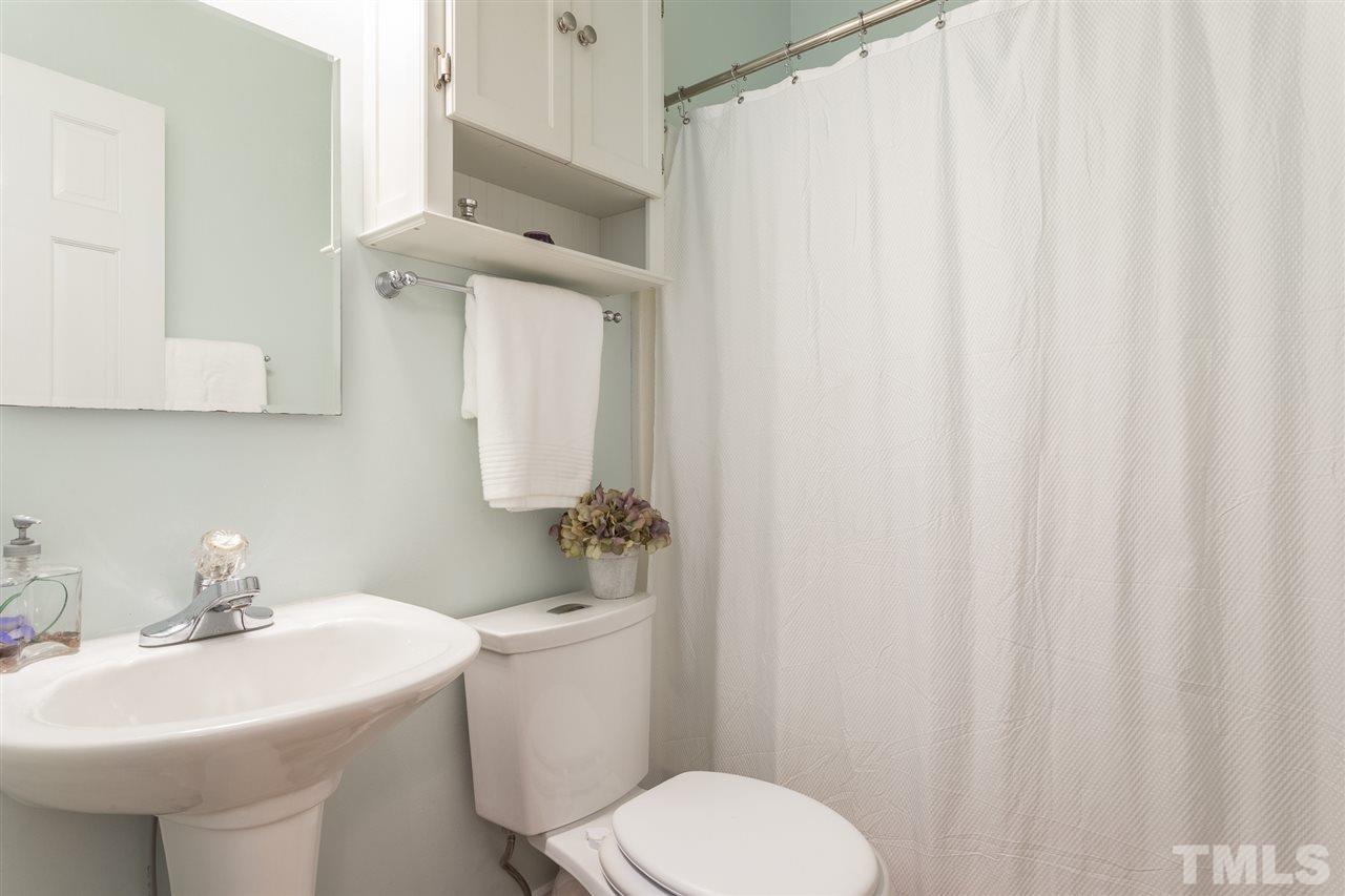 1208 Watauga Street Raleigh, NC 27604 - Photo 14 of 26 a bathroom with a sink a toilet and mirror