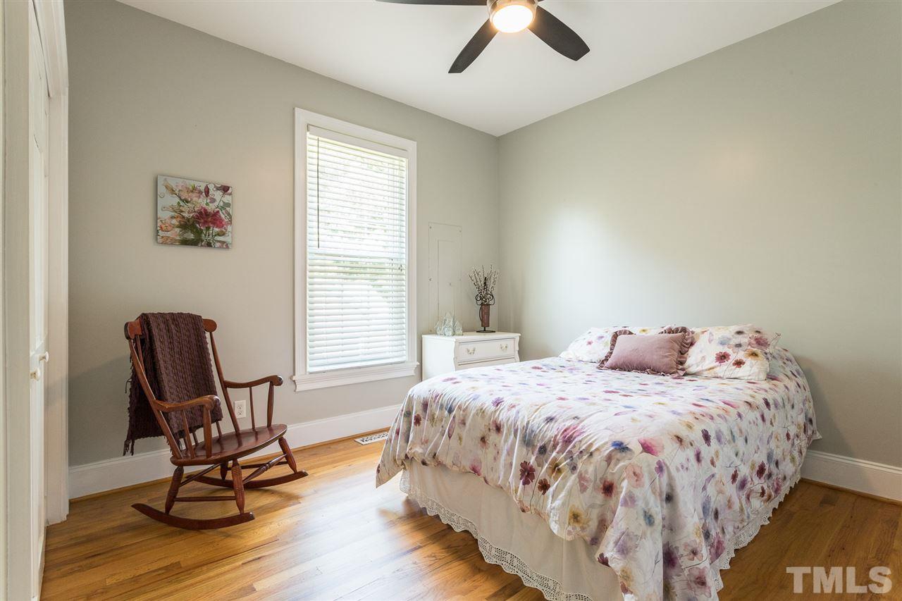 1208 Watauga Street Raleigh, NC 27604 - Photo 15 of 26 a bedroom with a bed chairs and two windows
