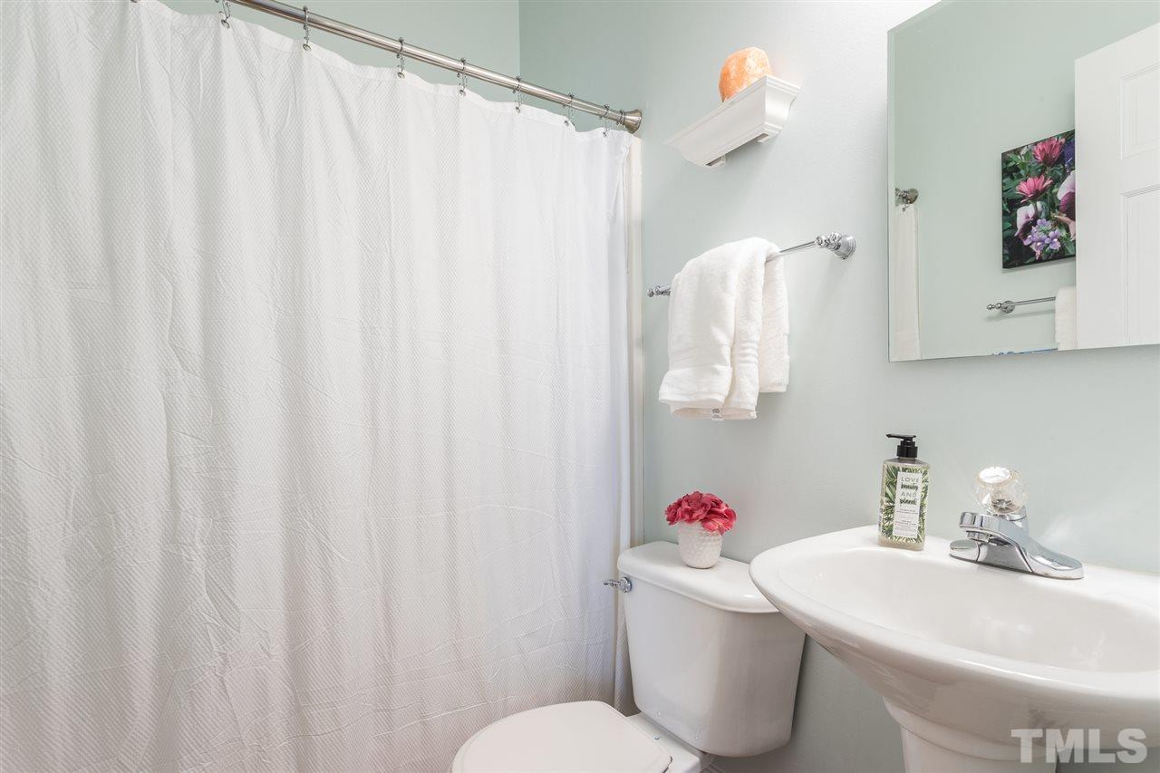 1208 Watauga Street Raleigh, NC 27604 - Photo 18 of 26 a bathroom with a sink toilet and a shower curtain