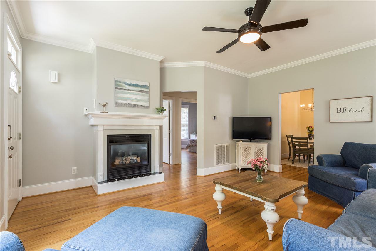1208 Watauga Street Raleigh, NC 27604 - Photo 3 of 26 a living room with furniture a flat screen tv and a fireplace