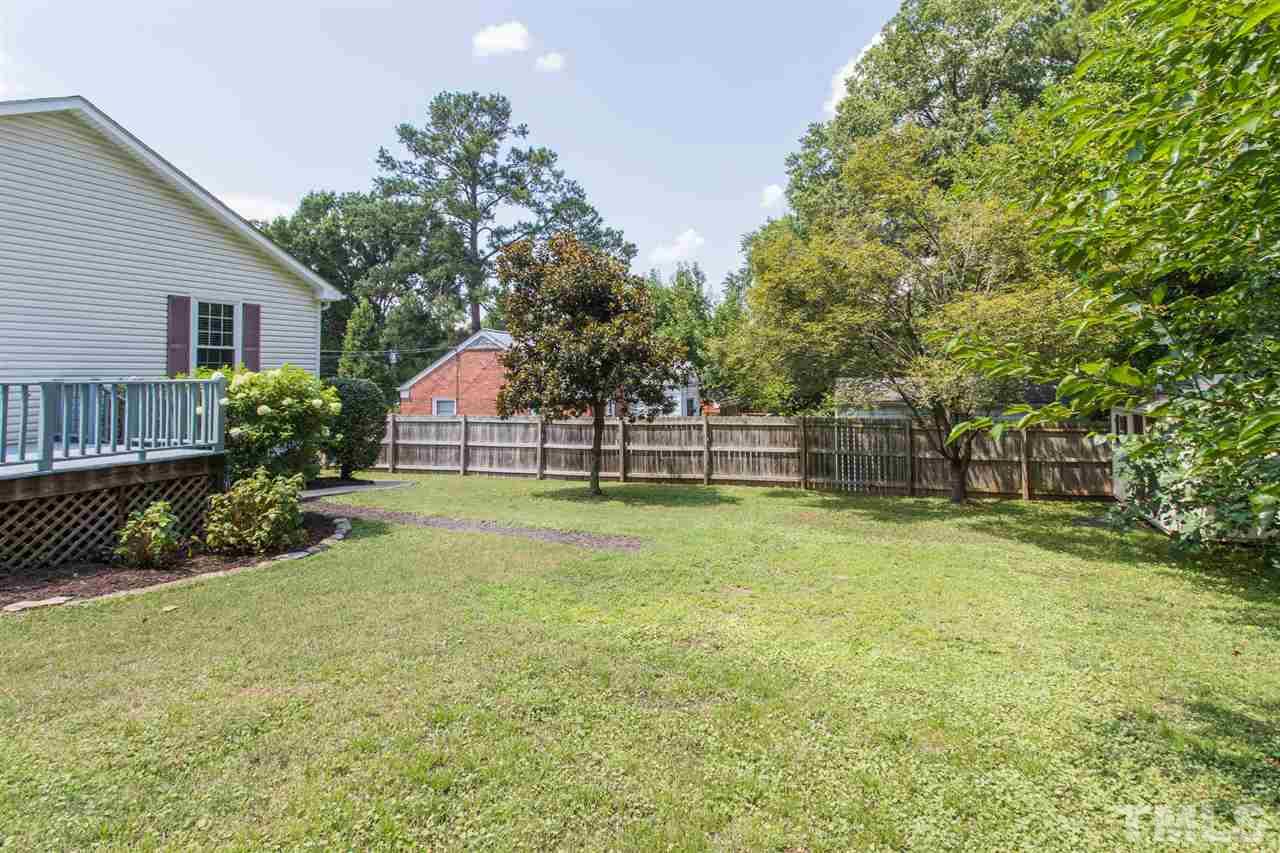 1208 Watauga Street Raleigh, NC 27604 - Photo 21 of 26 a view of a backyard with plants and large tree