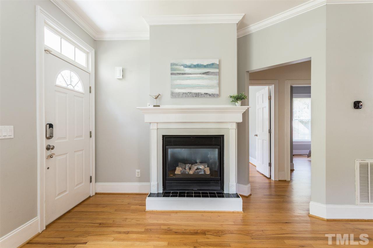 1208 Watauga Street Raleigh, NC 27604 - Photo 5 of 26 a living room with a fireplace and a fireplace