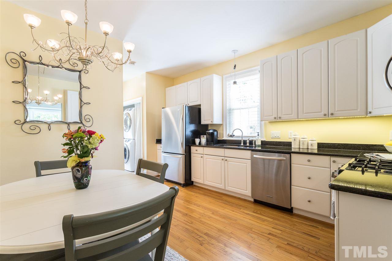 1208 Watauga Street Raleigh, NC 27604 - Photo 7 of 26 a kitchen with a table and chairs in it