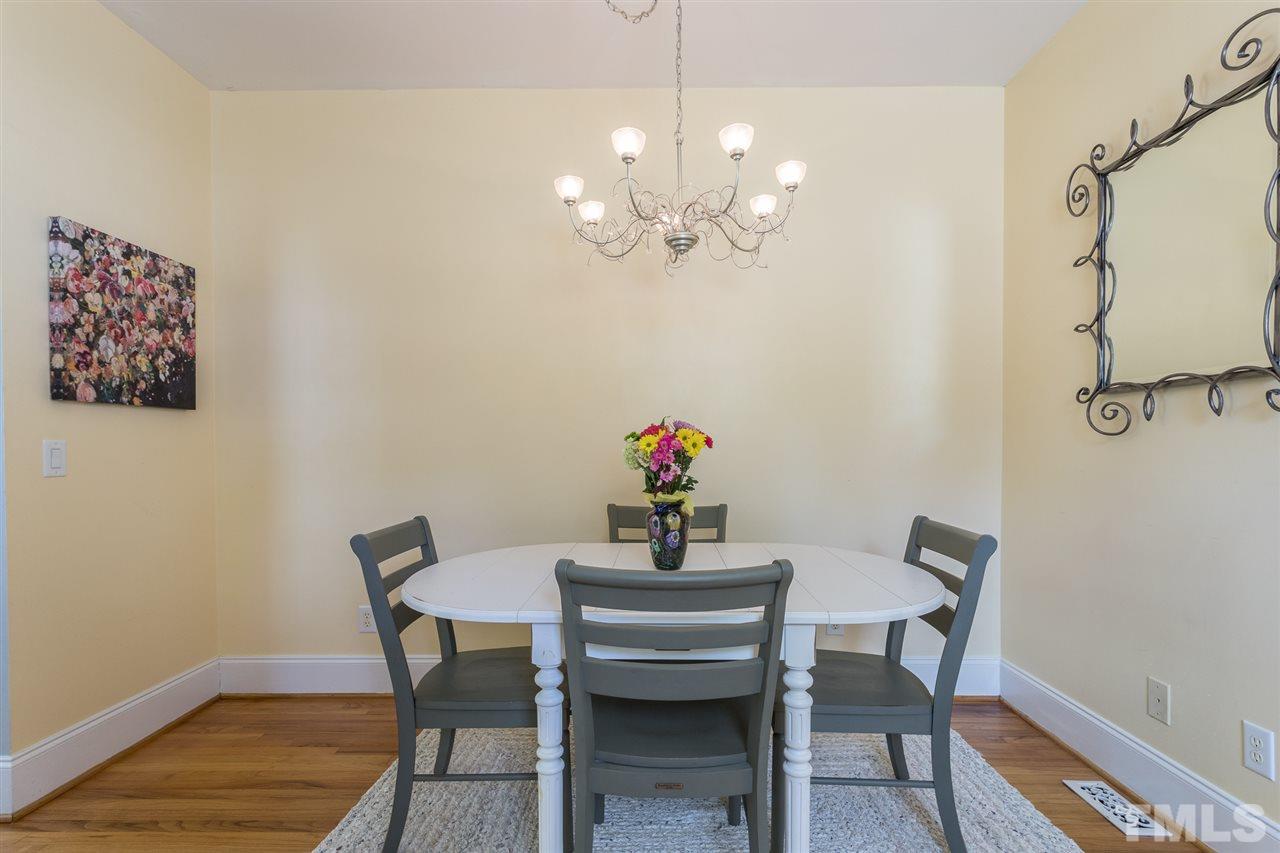 1208 Watauga Street Raleigh, NC 27604 - Photo 10 of 26 a view of a dining room with furniture and wooden floor