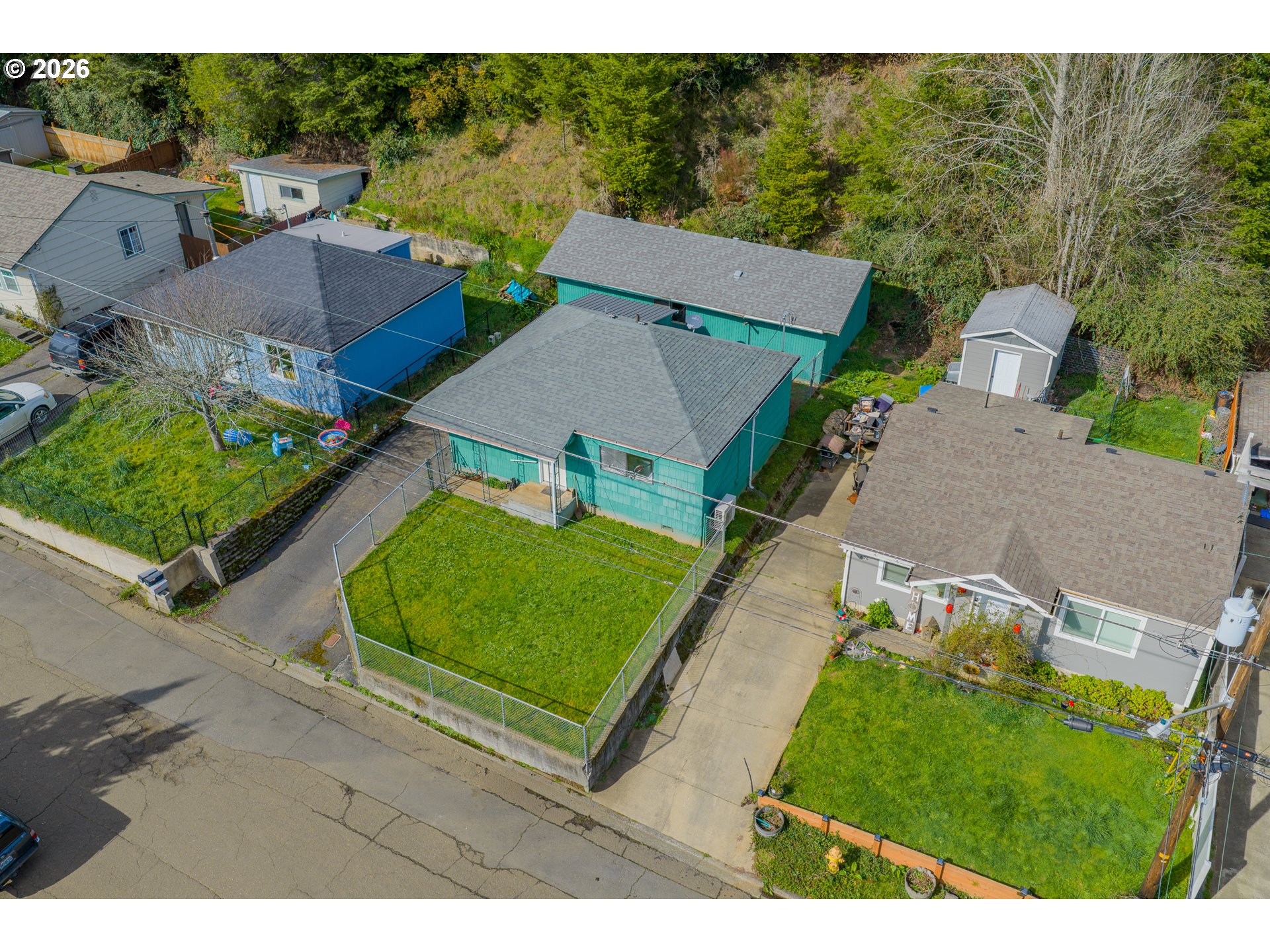 900 West 17th Street Coquille, OR 97423 - Photo 3 of 36 an aerial view of a house with a garden and trees