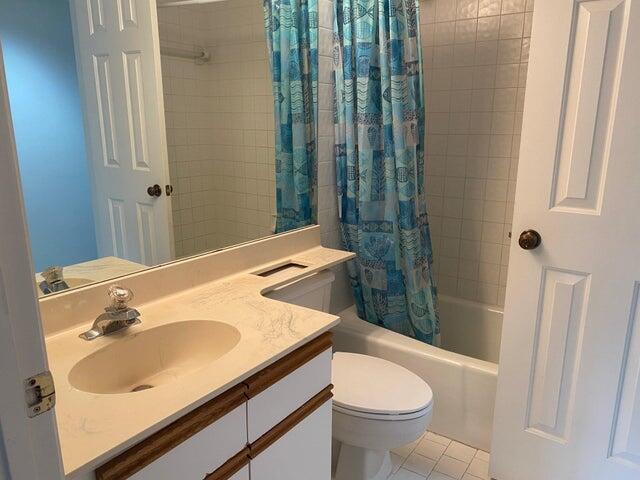 12692 Shoreline Drive, Unit 3C Wellington, FL 33414 - Photo 12 of 12 a bathroom with a sink toilet and shower