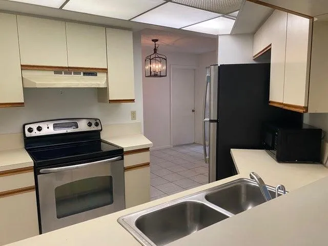 a kitchen with a refrigerator sink and stove