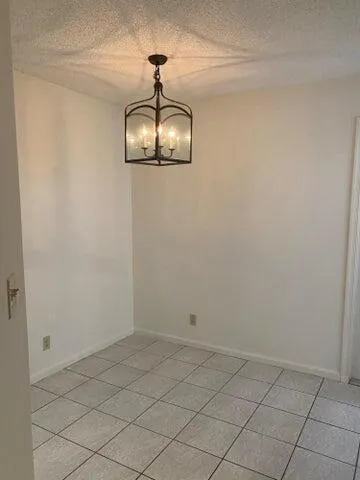 a view of a chandelier fan in a room