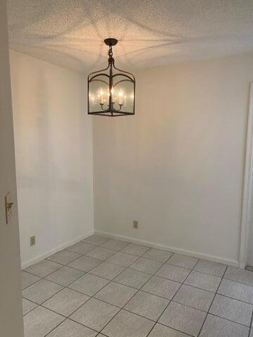 12692 Shoreline Drive, Unit 3C Wellington, FL 33414 - Photo 7 of 12 a view of a chandelier fan in a room