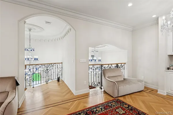 a living room with furniture and a chandelier