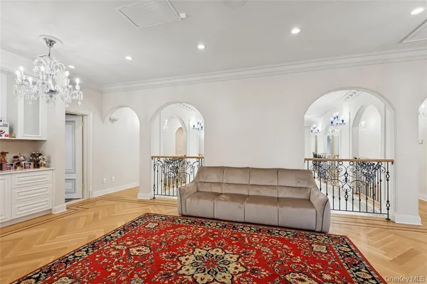 a view of a hallway with furniture and a chandelier