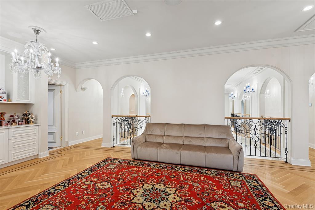 1190 Harbor Road Hewlett Harbor, NY 11557 - Photo 20 of 49 a living room with furniture and a chandelier