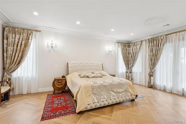 a bedroom with a bed and a flat tv screen on the table