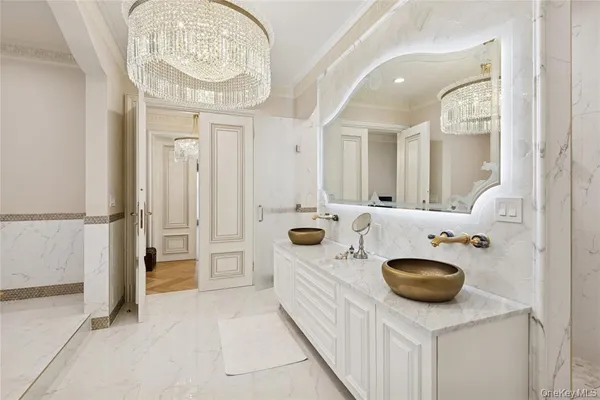 a spacious bathroom with a tub a double vanity sink and a mirror