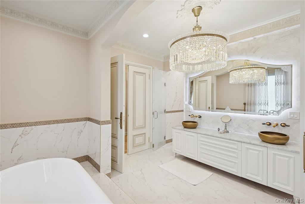1190 Harbor Road Hewlett Harbor, NY 11557 - Photo 29 of 49 a spacious bathroom with a tub a double vanity sink and a mirror