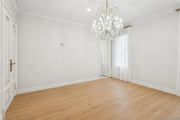 a view of a chandelier in big room and windows