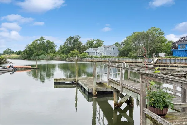 a view of a lake with houses in the back