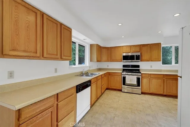 a kitchen with stainless steel appliances granite countertop a sink and cabinets