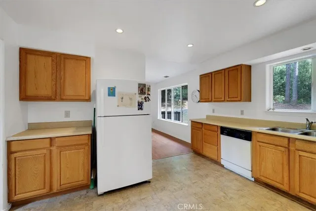 a kitchen with granite countertop a sink stove and cabinets