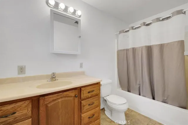 a bathroom with a sink vanity mirror and toilet