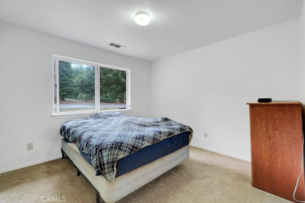 15721 Norcrest Lane Camptonville, CA 95922 - Photo 24 of 43 a bed sitting in a spacious bedroom next to a window