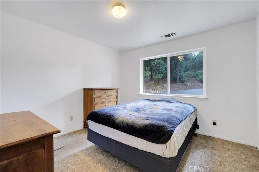 15721 Norcrest Lane Camptonville, CA 95922 - Photo 27 of 43 a bed sitting in a room next to a window