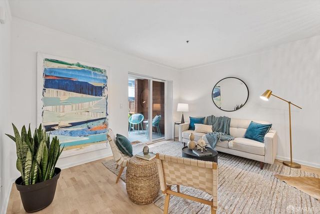 a living room with furniture a rug and a large window
