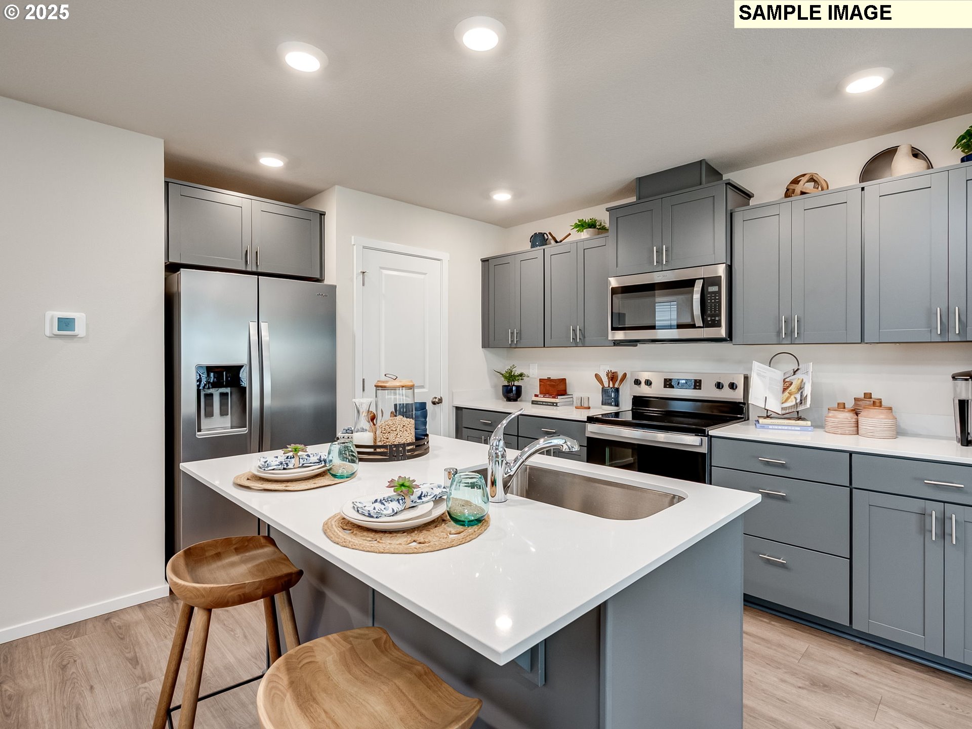 11112 Southeast Maxon Road Vancouver, WA 98664 - Photo 5 of 31 a kitchen with refrigerator cabinets and wooden floor